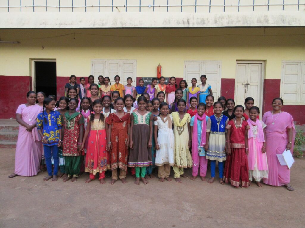 Primary and middle school girls in front of the Athipet home